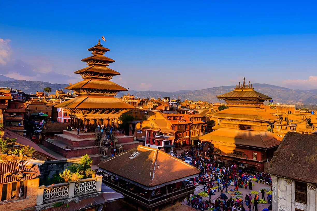 A vibrant aerial view of the ancient city of Bhaktapur, Nepal, at sunset.